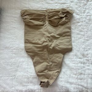 SKIMS Seamless Sculpt Strapless Thong Bodysuit in Clay